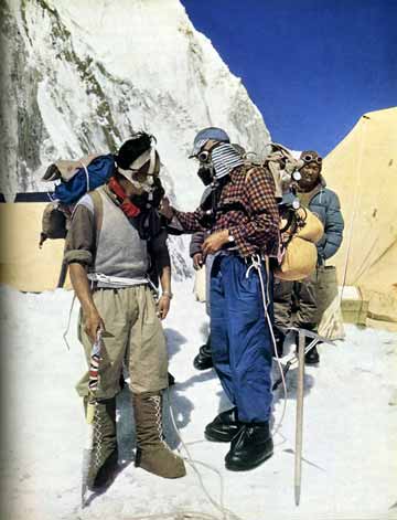 
Edmund Hillary, wearing his inimitable hat and check shirt, is turning on the oxygen for Tenzing Norgay as they prepare to leave base camp for the summit of Mount Everest. - The Picture Of Everest book
